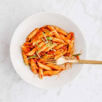 penne arrabiata in einem teller mit einer goldenen gabel