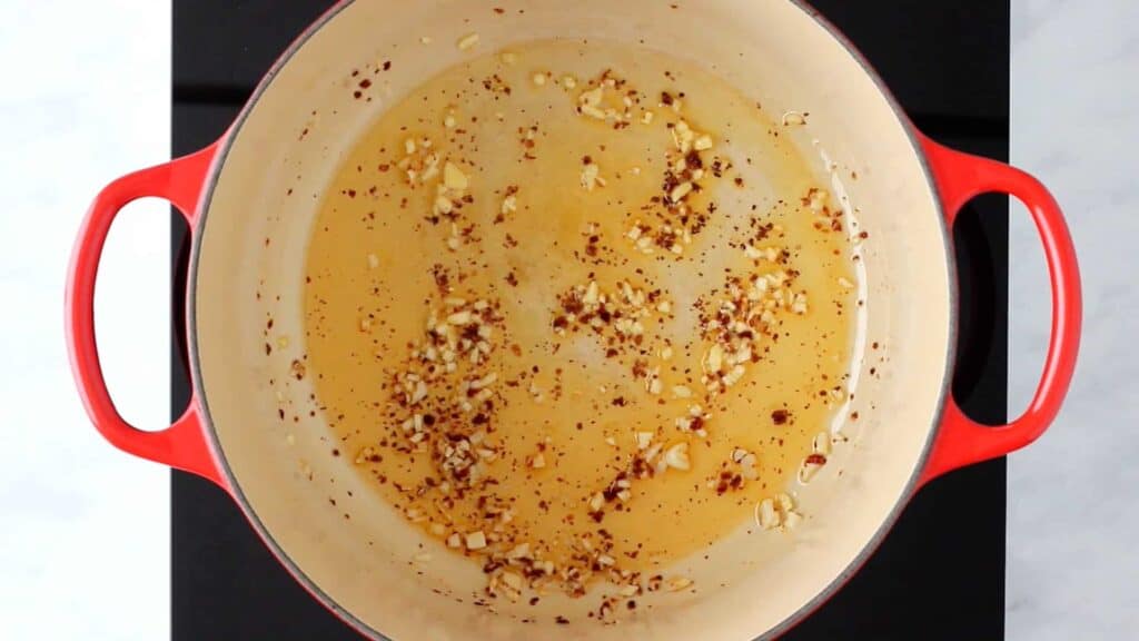 a pot with olive oil, garlic, and red pepper flakes