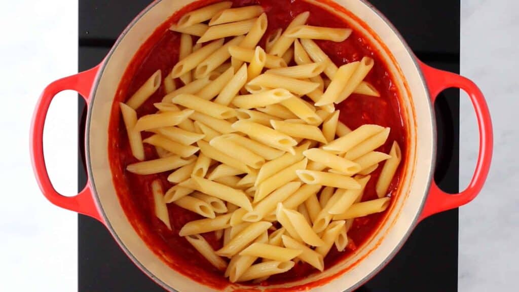 cooked penne in a pot with arrabiata sauce