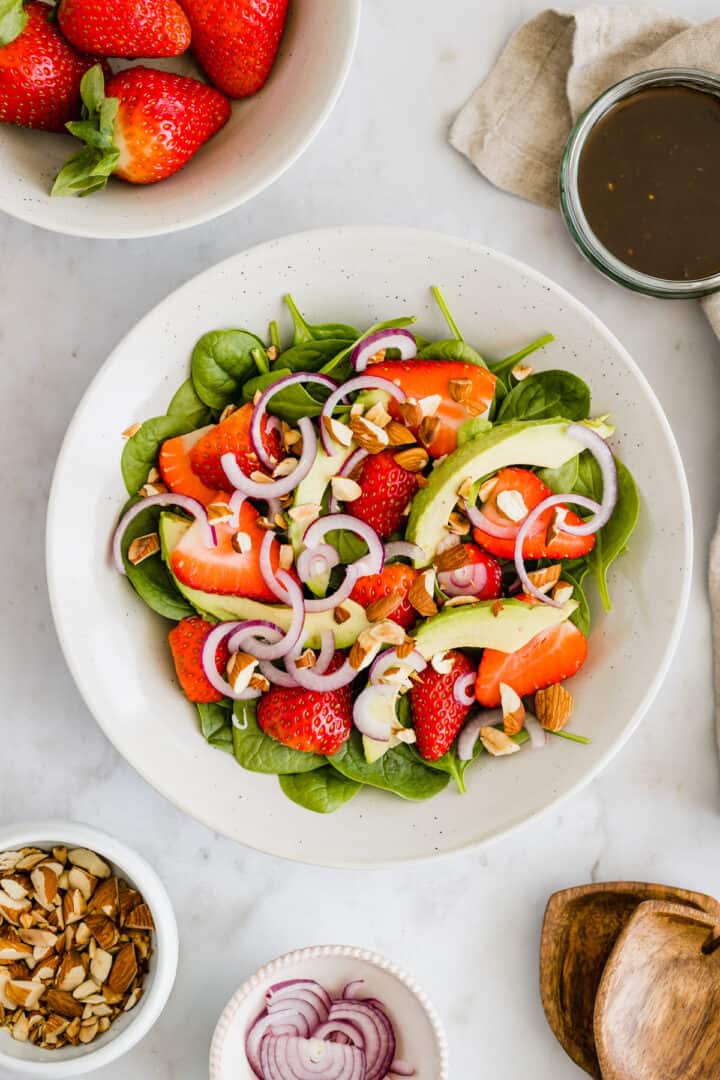 spinach strawberry almond salad in a bowl