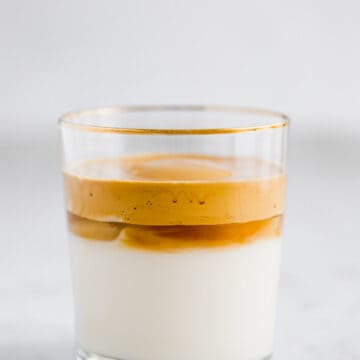 dalgona coffee with oat milk in a glass