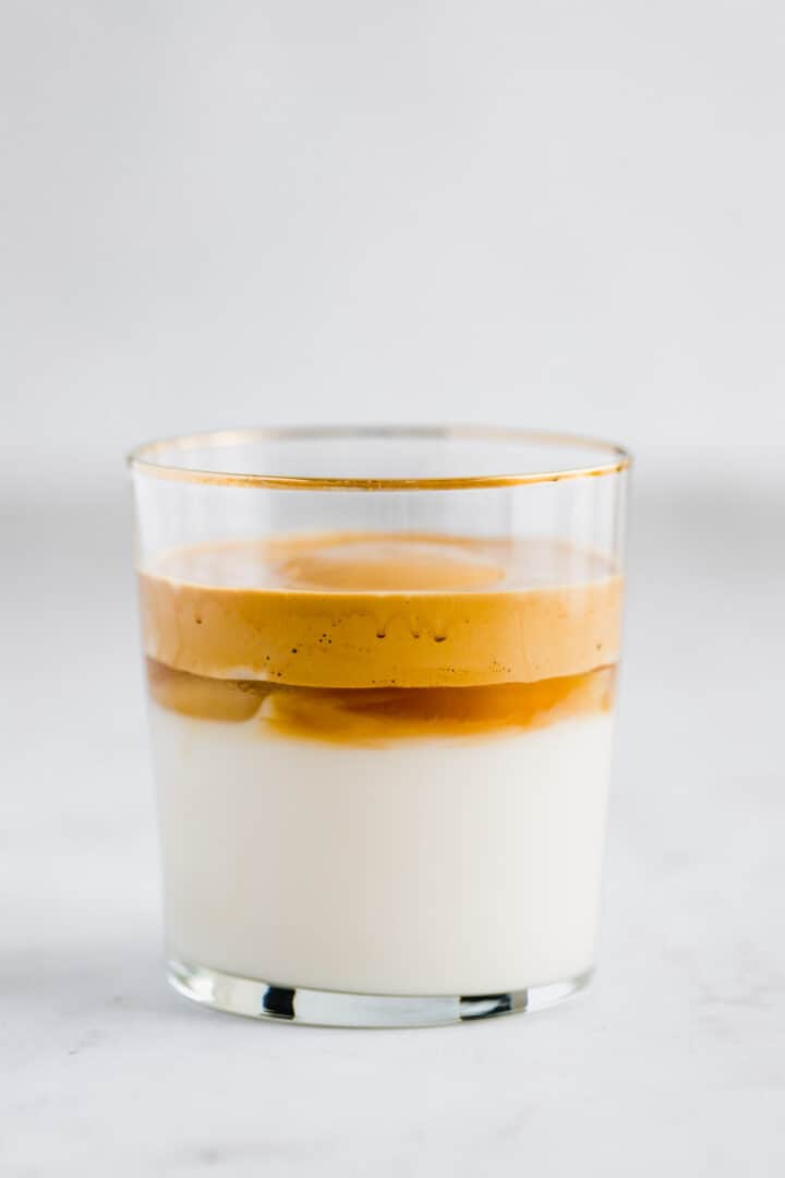 dalgona coffee with oat milk in a glass
