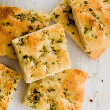 focaccia slices stapled next to a bowl with olive oil