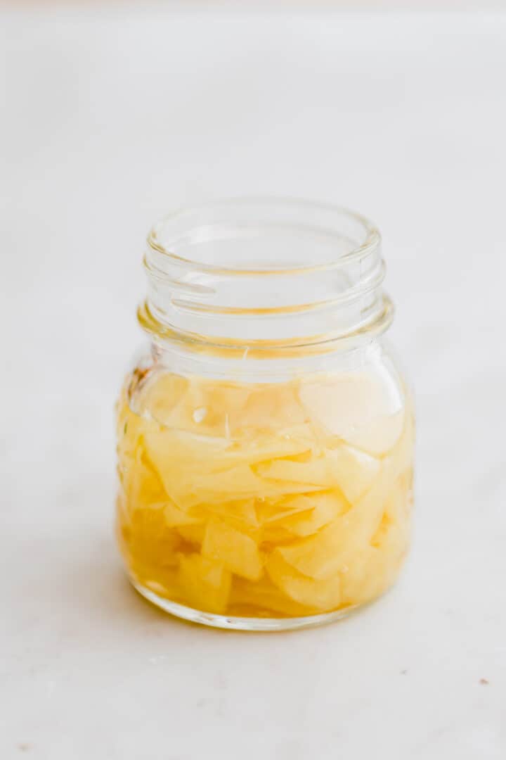 a glass with freshly pickled ginger