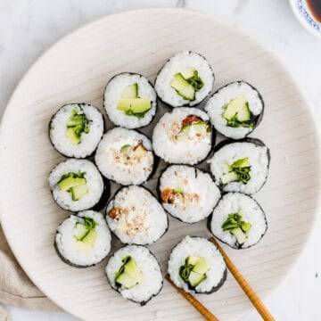 two chopsticks taking a sushi roll