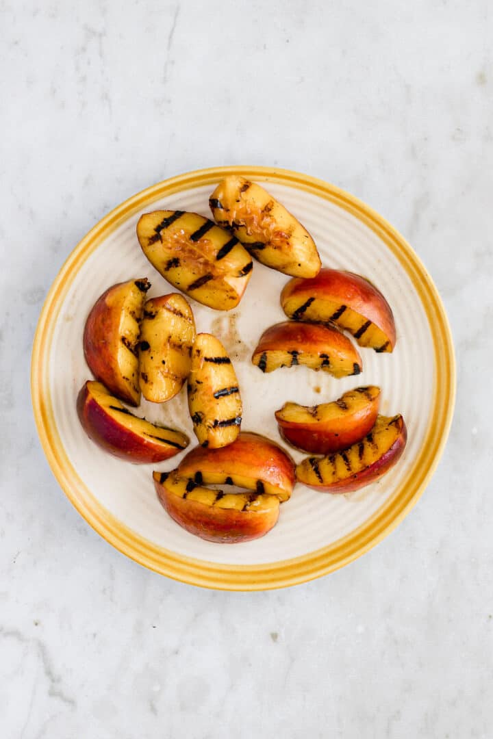grilled peach wedges on a plate