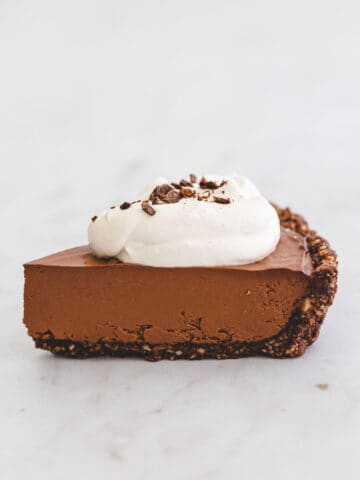 a piece of chocolate pie with dairy free whipped cream on top