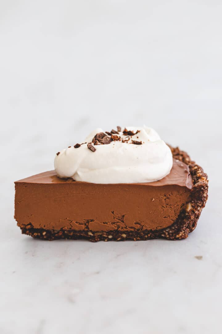 a piece of chocolate pie with dairy free whipped cream on top