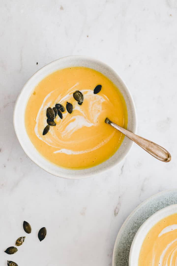 butternut soup topped with coconut milk and pumpkin seeds