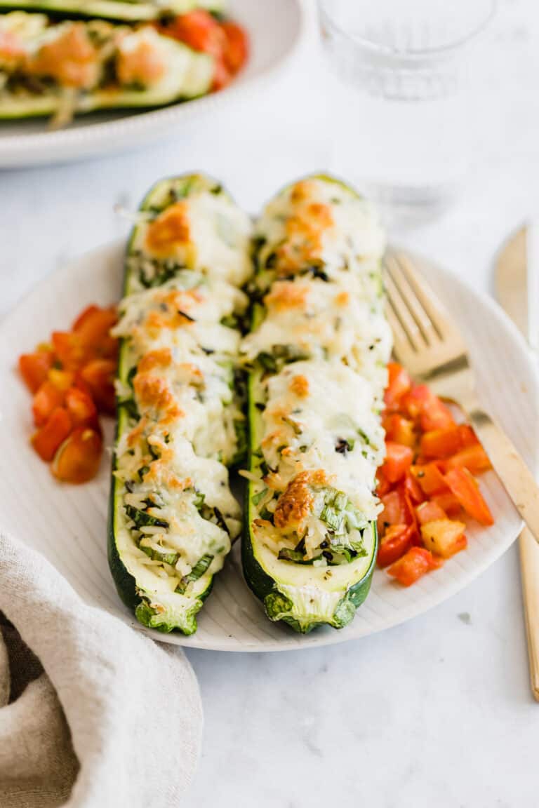 vegetarian zucchini boats filled with rice on a plate