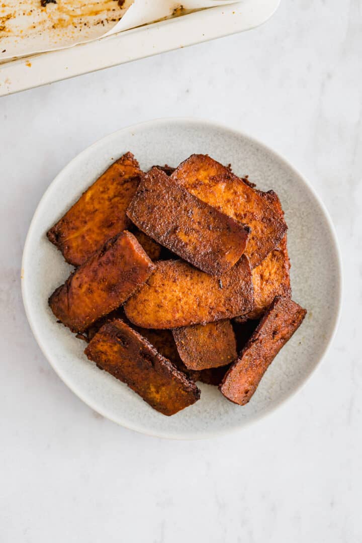 vegan tofu bacon on a blue plate