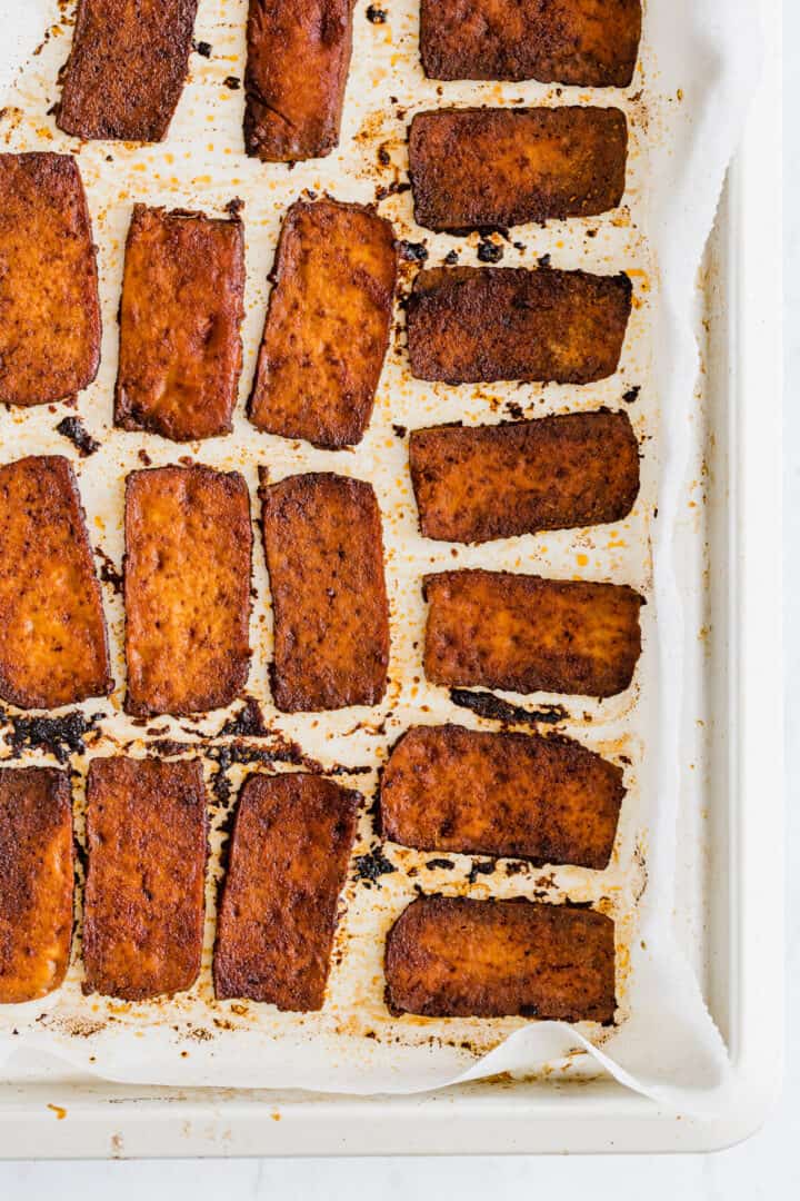 baked vegan bacon made with tofu on a baking tray