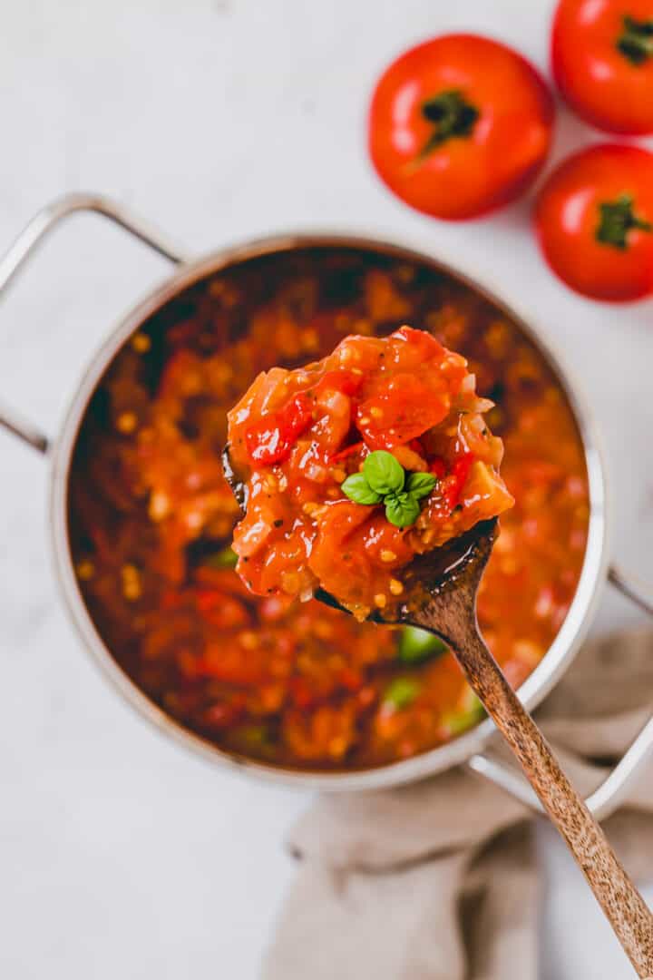 a spoon with homemade spaghetti sauce with fresh tomatoes