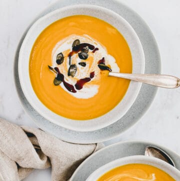 pumpkin ginger soup topped with coconut milk, pumpkin seeds, and pumpkin seed oil