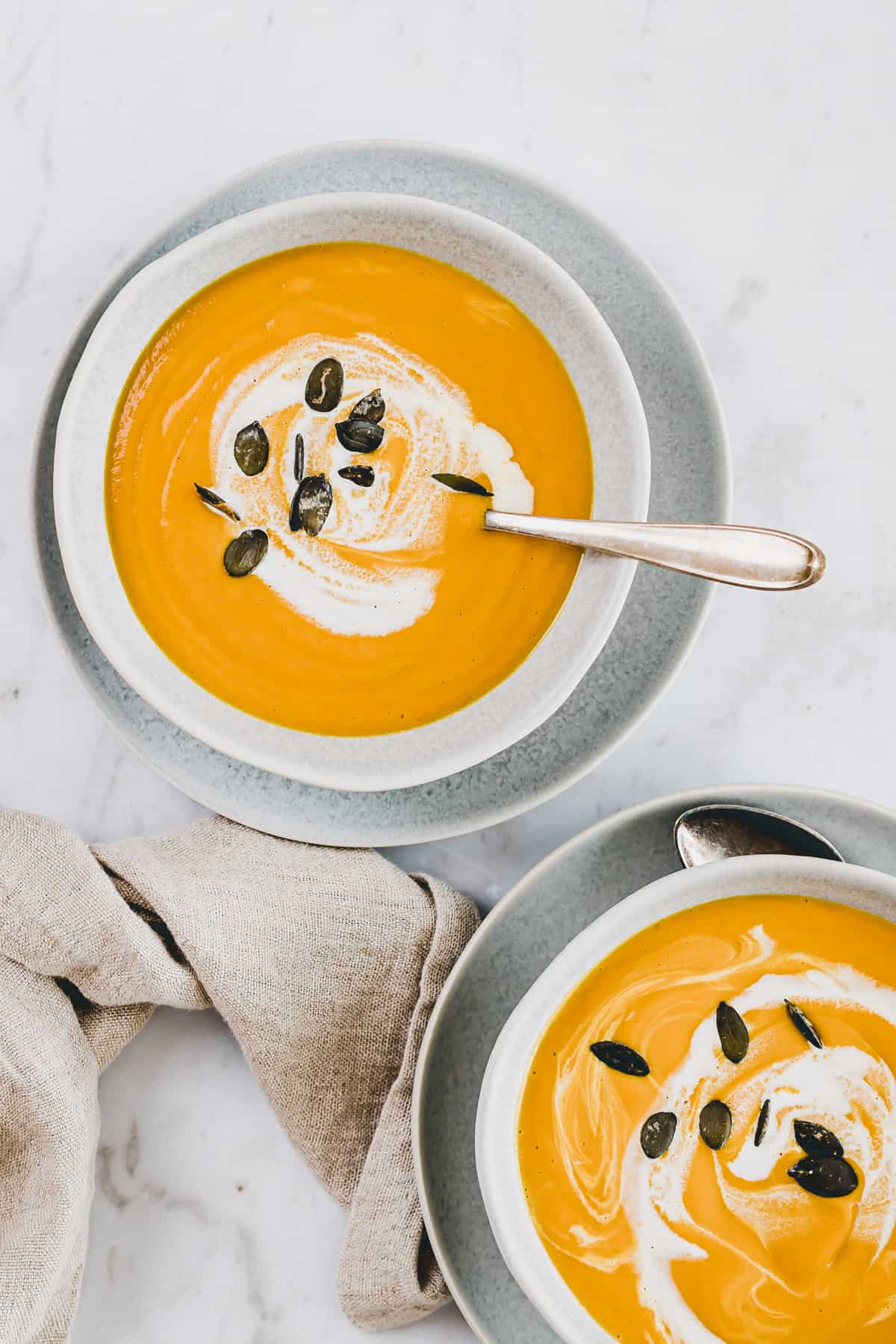 soup with pumpkin and ginger in two blue bowls