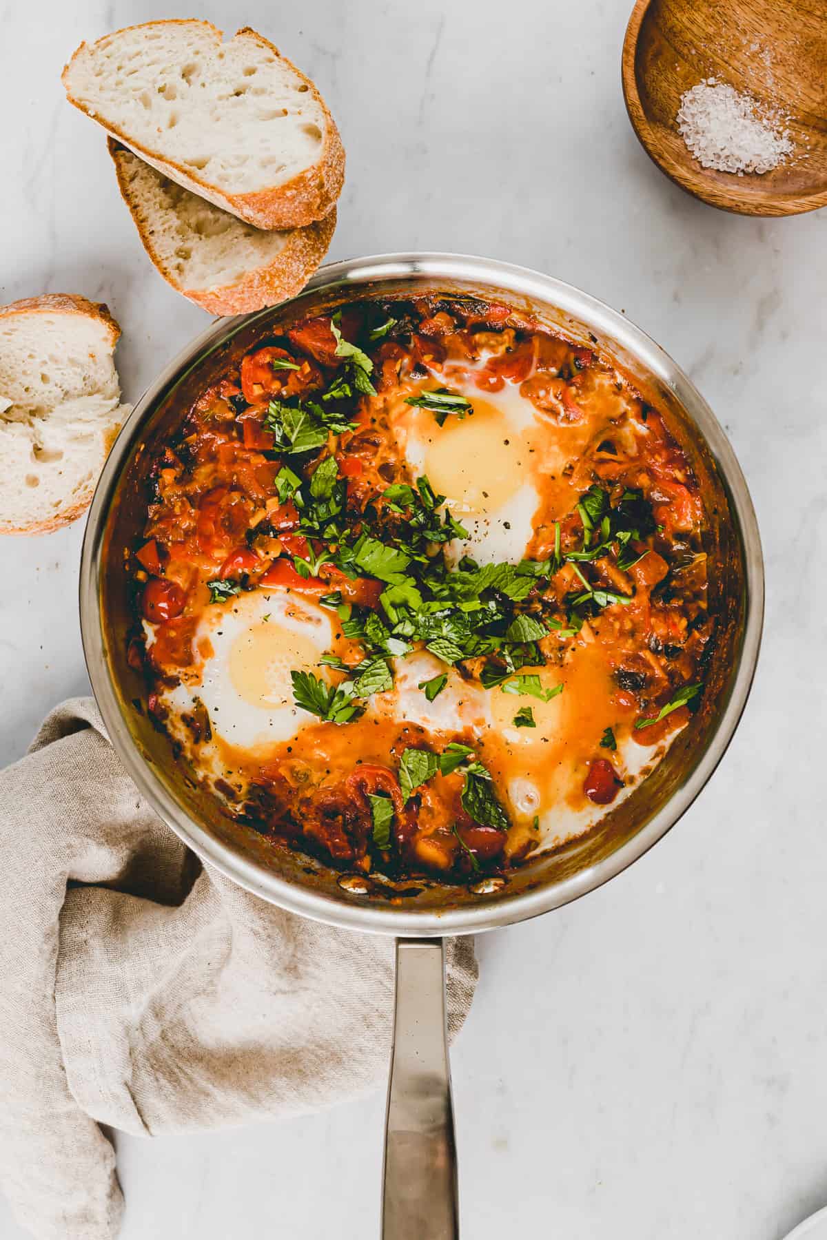 homemade shakshuka with fresh tomatoes served in a skillet