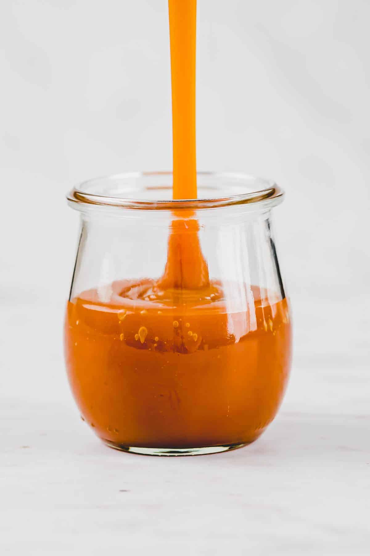 vegan caramel sauce in a tulip jar