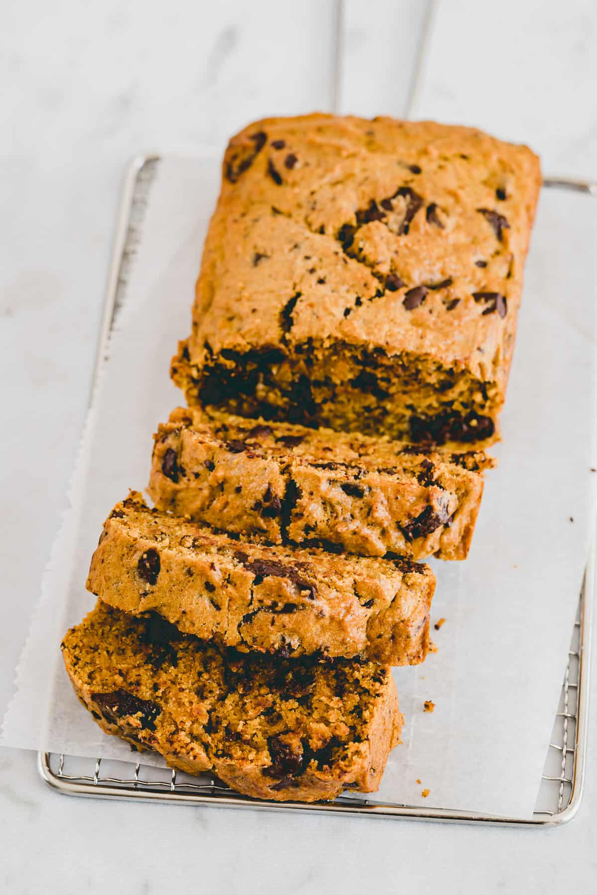 a loaf healthy pumpkin chocolate chip bread on a white parchment paper