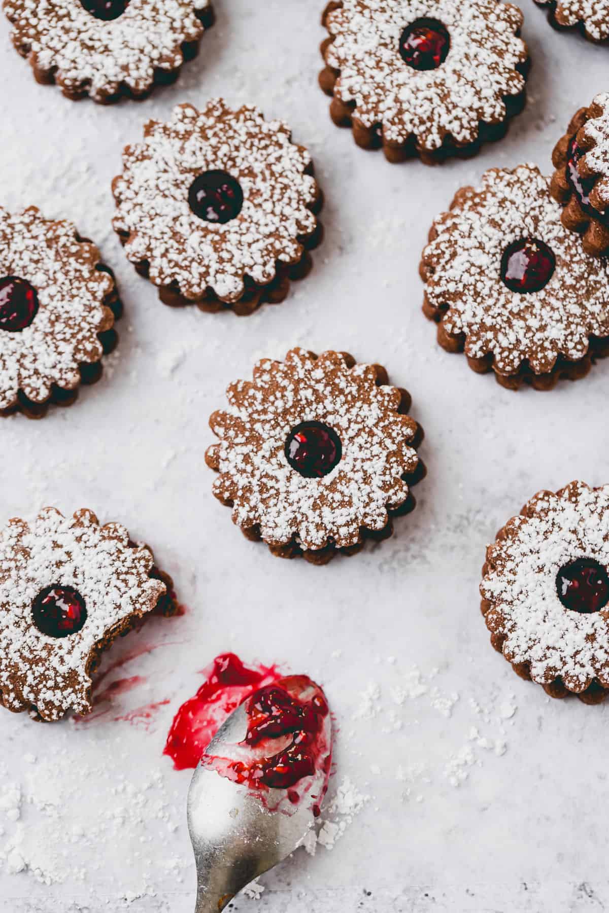 vegan linzer cookies with cacao powder and raspberry filling