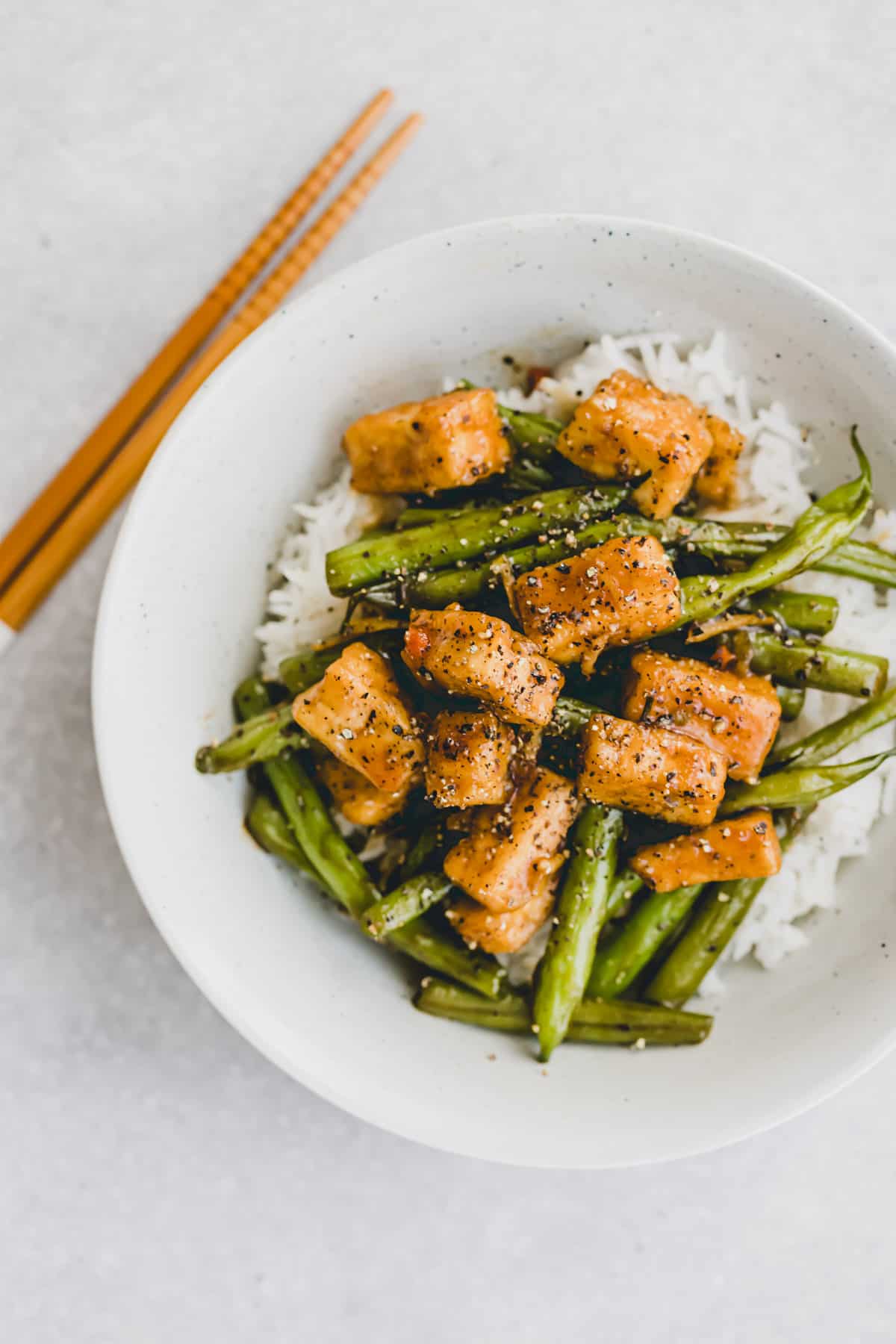 black pepper tofu with green beans on rice