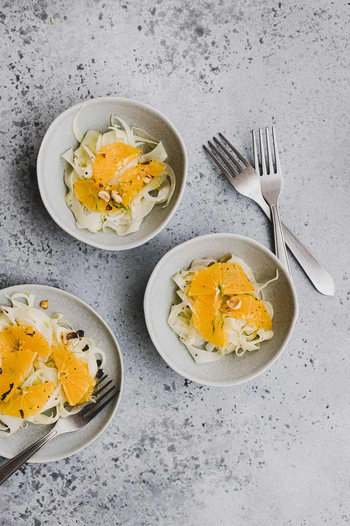 fennel orange salad in 3 blue bowls