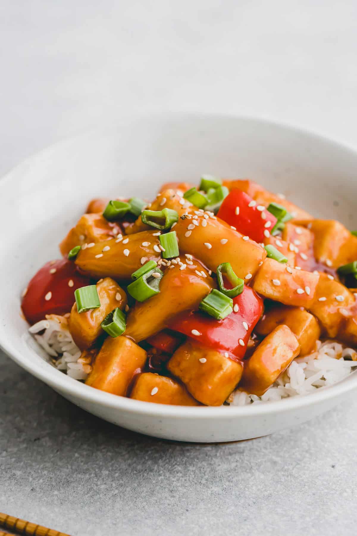 a bowl of tofu sweet and sour with rice