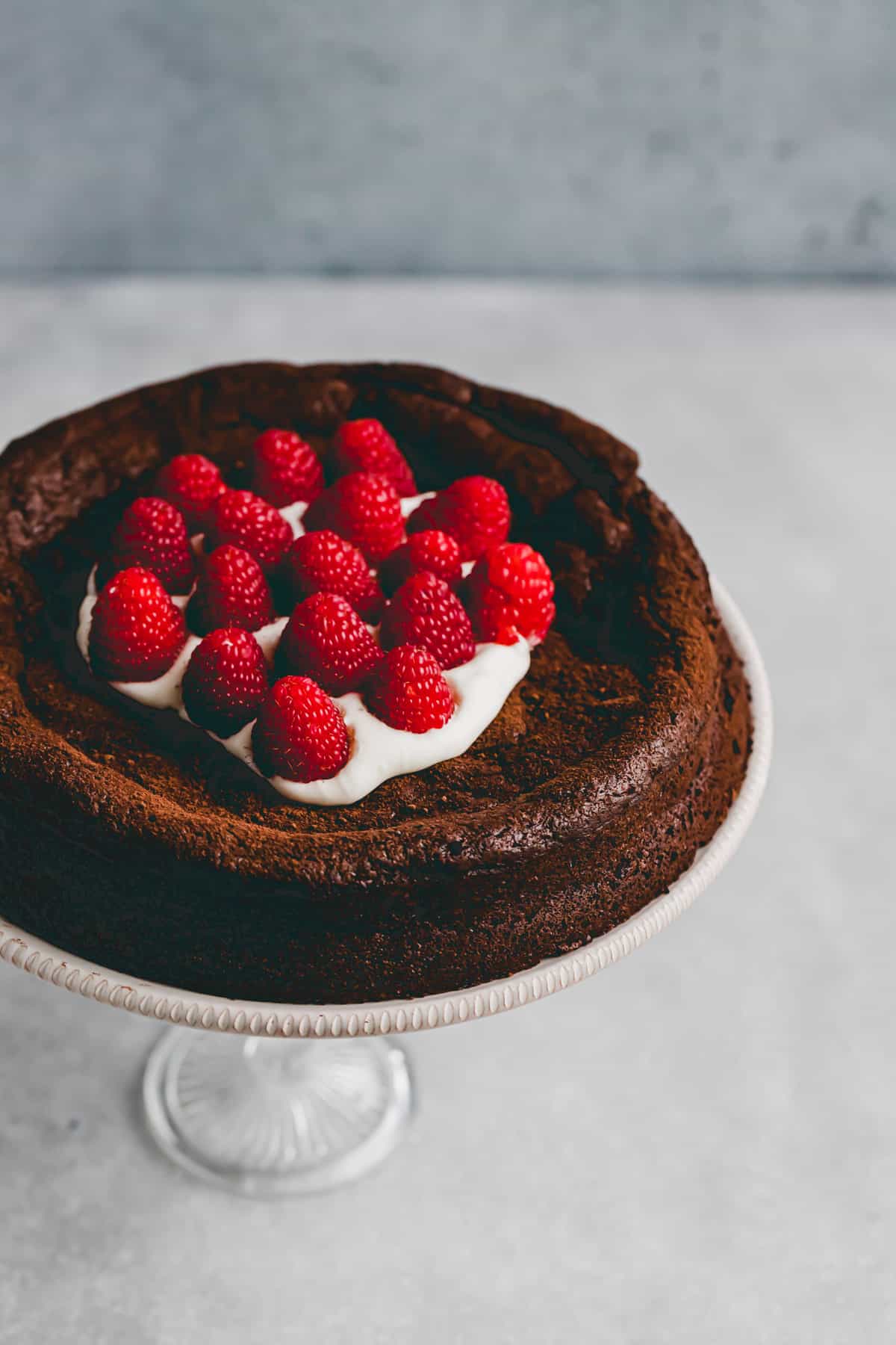 paleo flourless chocolate cake on a cake stand