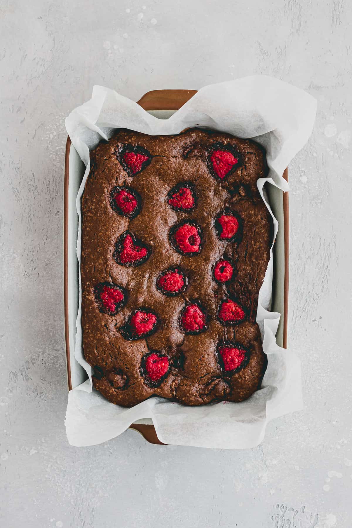 chocolate raspberry brownies in a baking pan