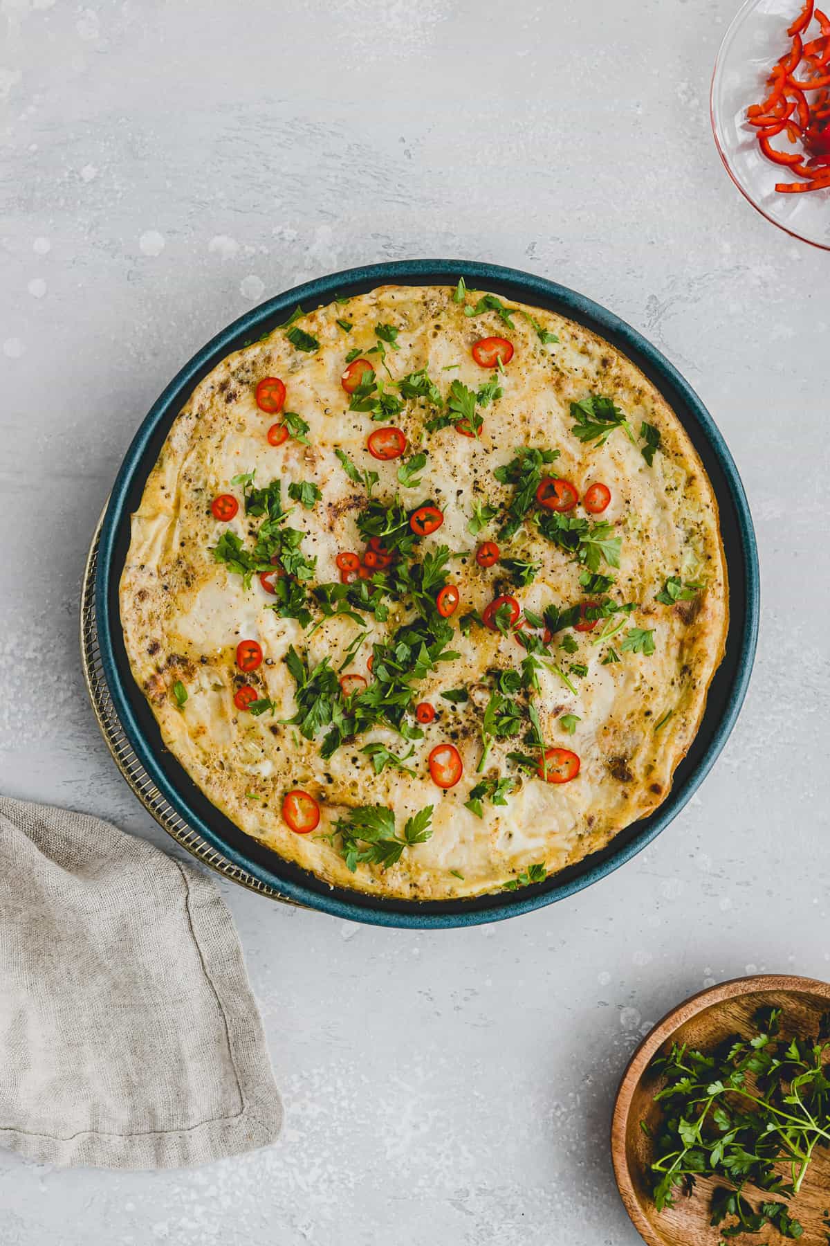 leek and parmesan frittata on a blue plate