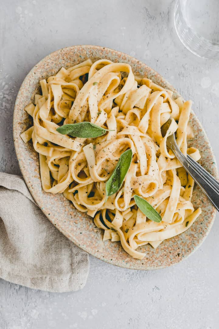 vegane alfredo kürbis pasta auf einem servierteller