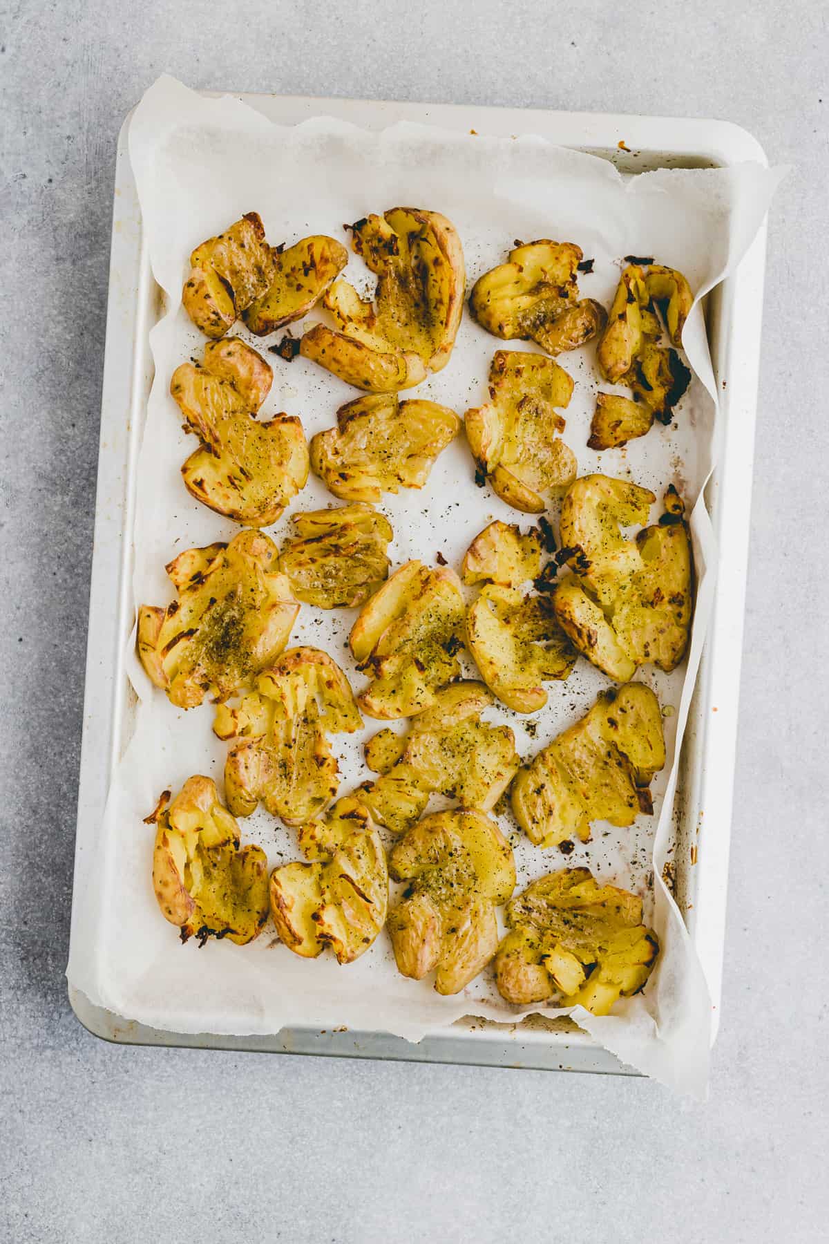 smashed potatoes on a baking sheet