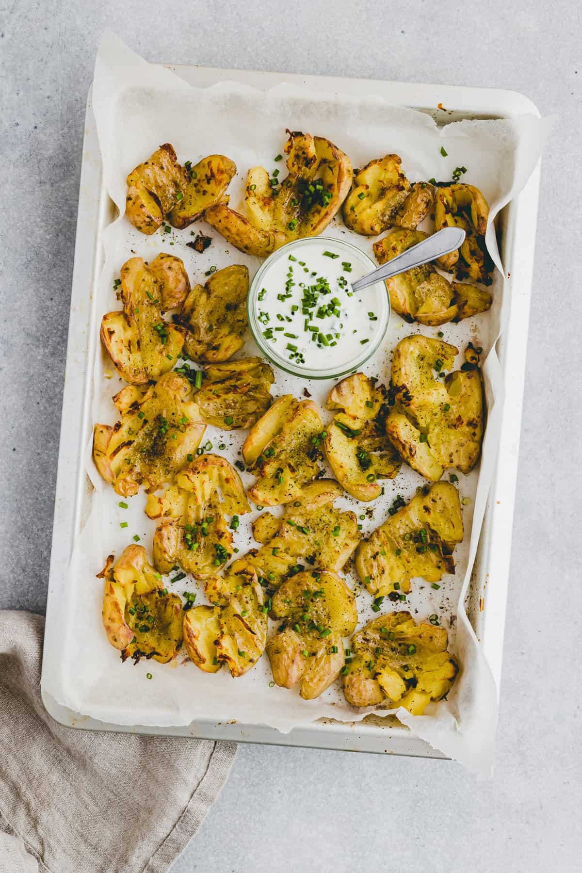 smashed baby potatoes with a white dip