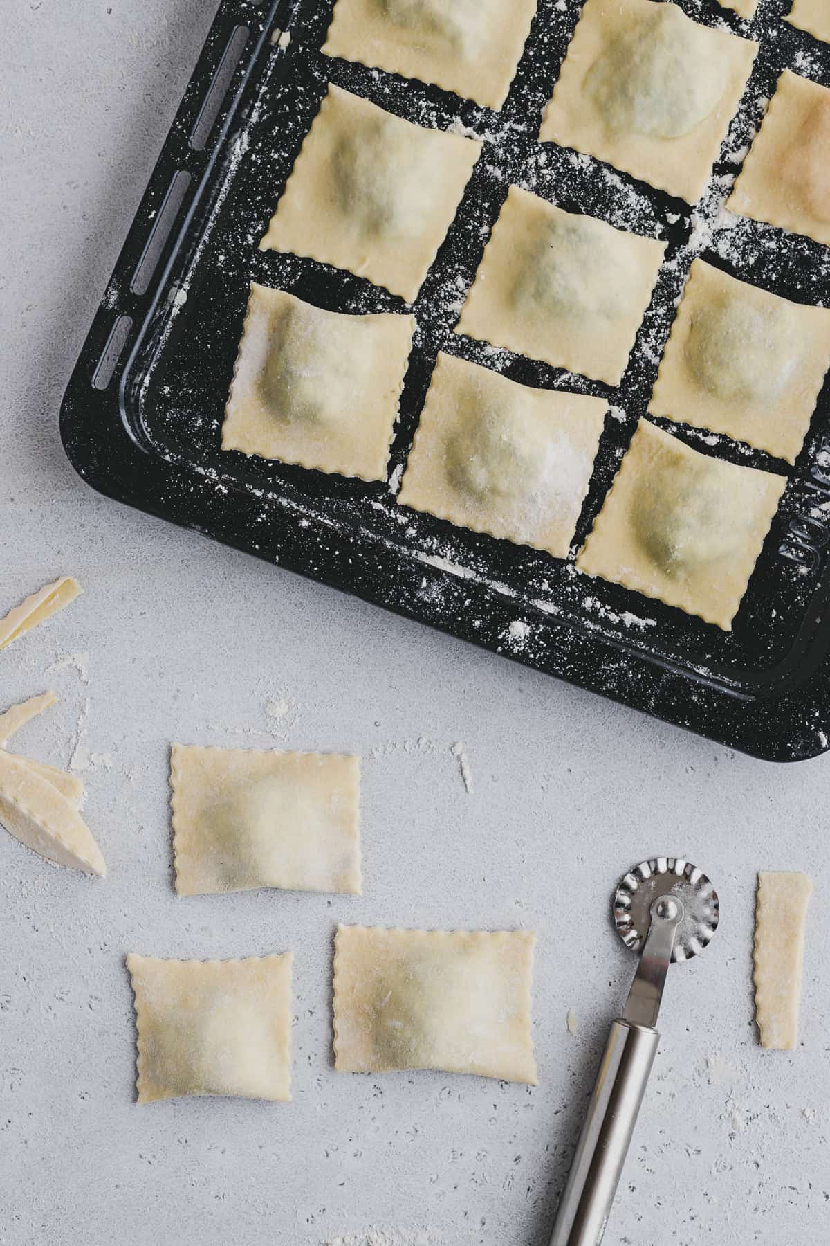 ravioli stored on a floured baking tray