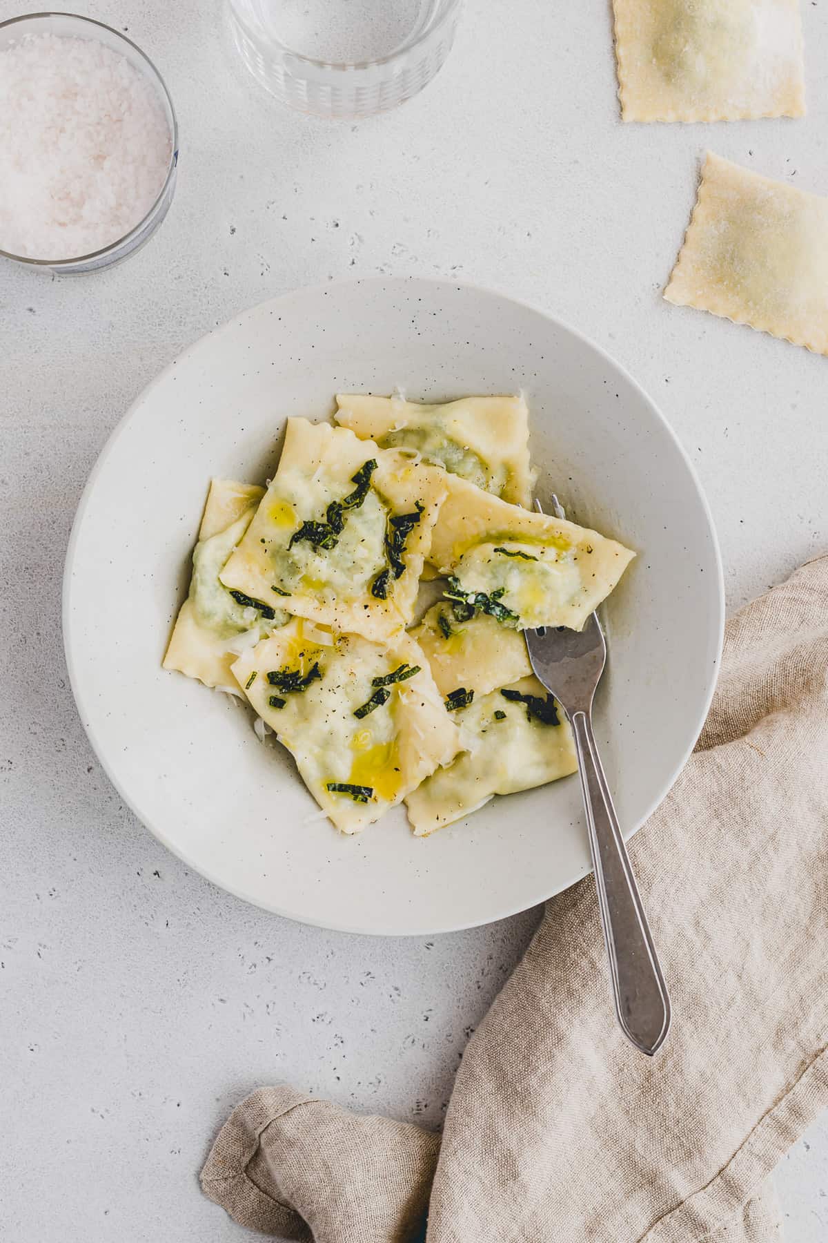 spinach ricotta ravioli served in a pasta plate