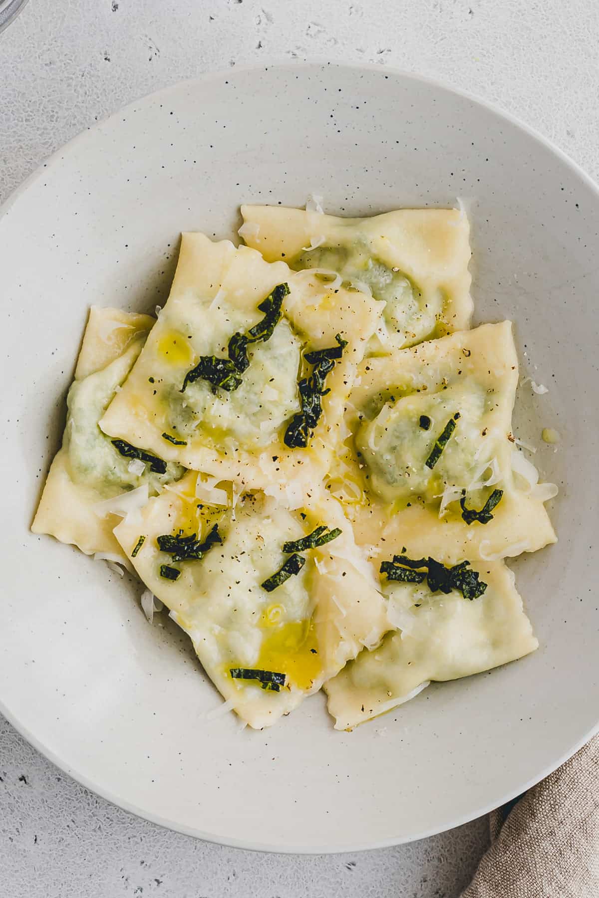 spinach and ricotta ravioli drizzled with olive oil and sage