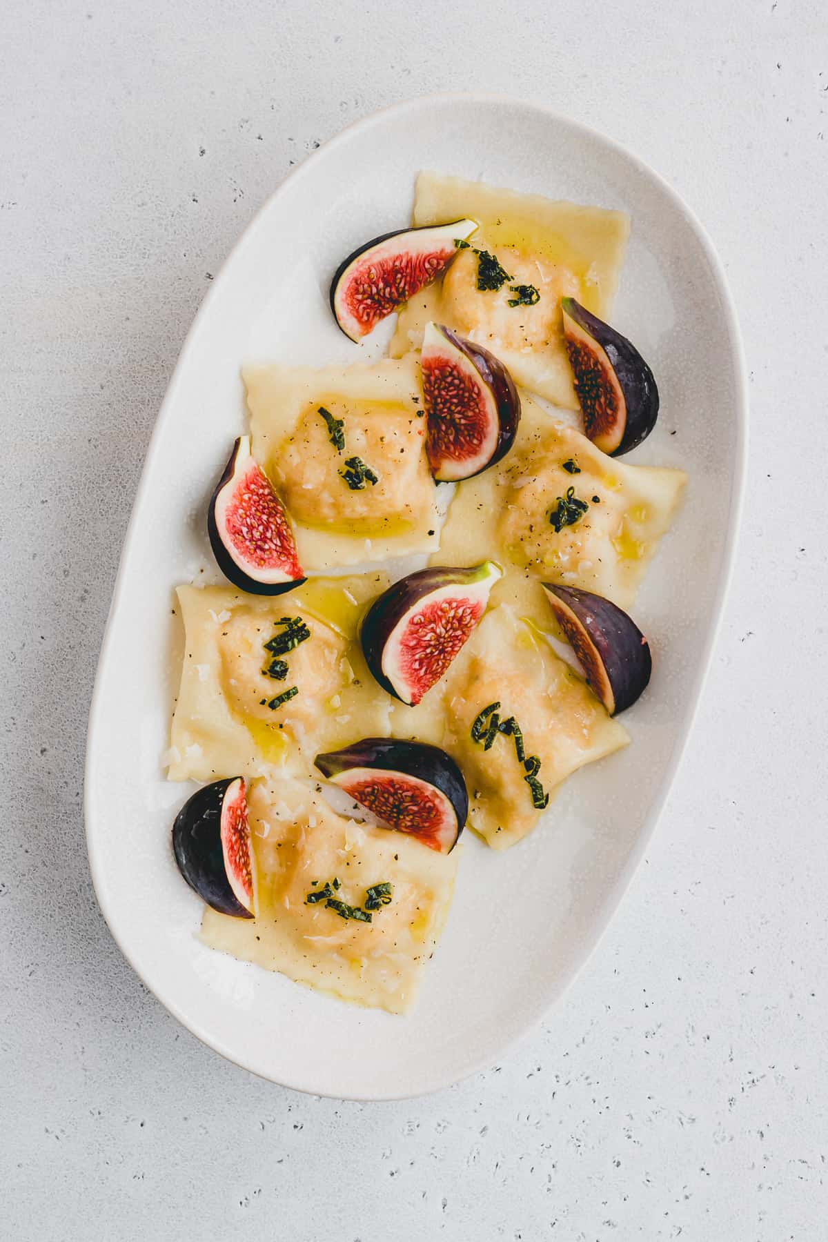 pumpkin ravioli served on a plate with fresh figs