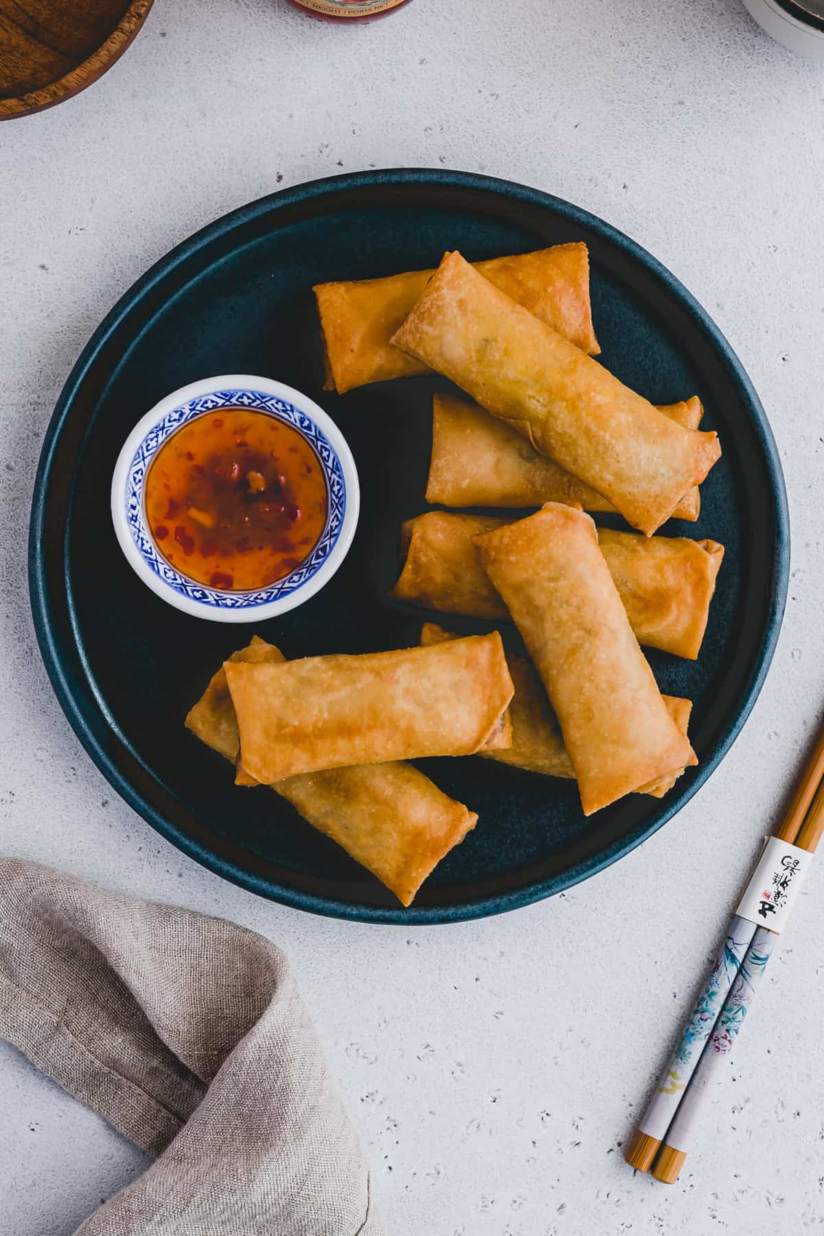 homemade spring rolls on a plate with with sweet chili sauce