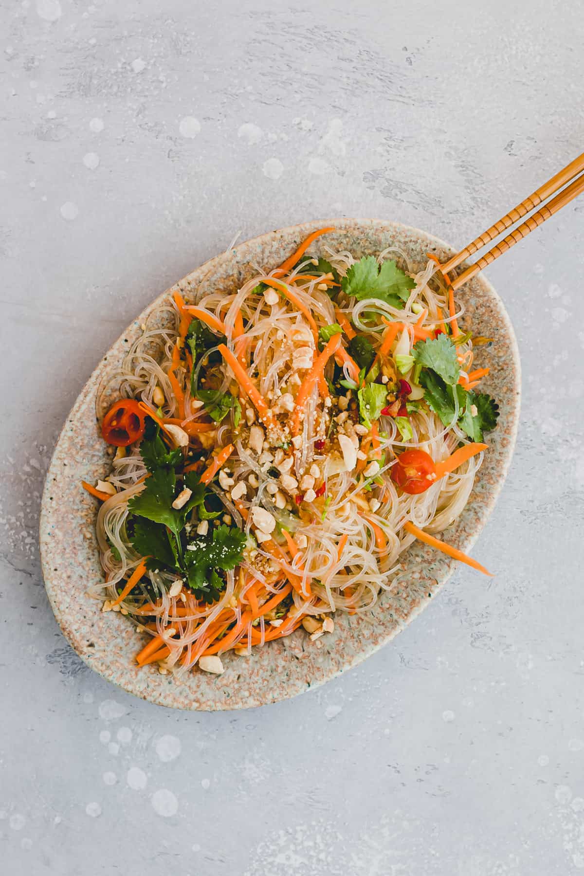 vegan thai glass noodle salad on a plate with chopsticks