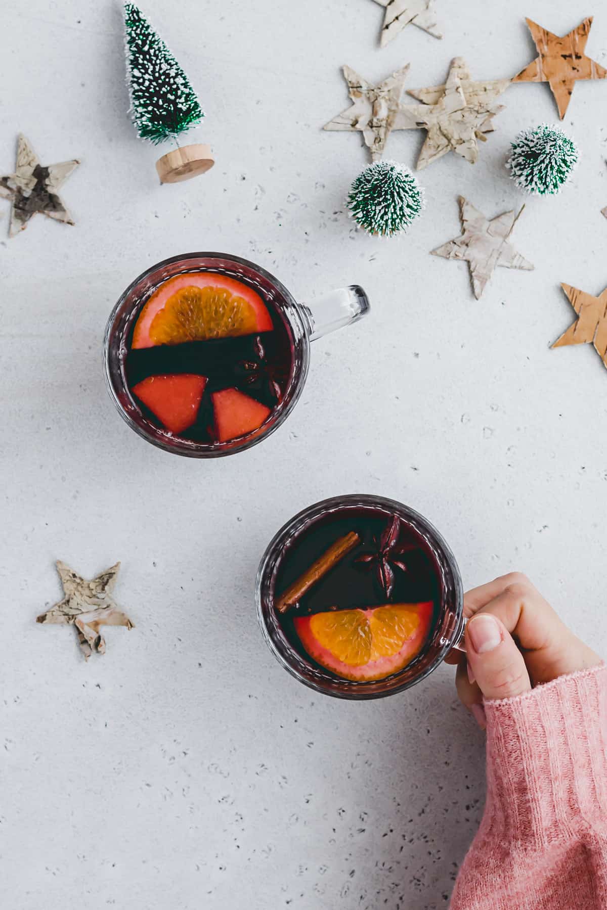 a hand holding a glass of homemade mulled wine