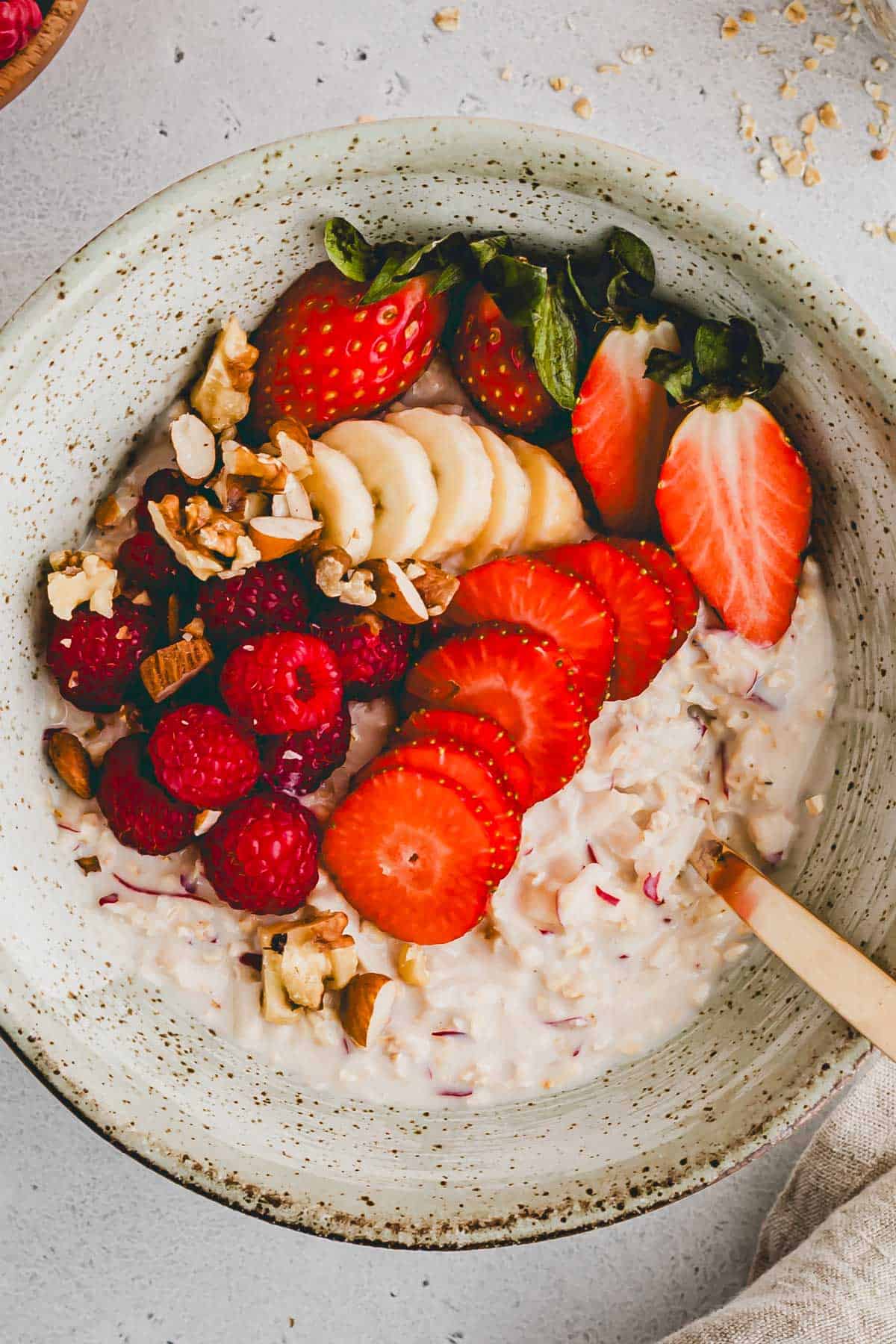 birchermüesli mit joghurt und frischen früchten in einer schüssel serviert