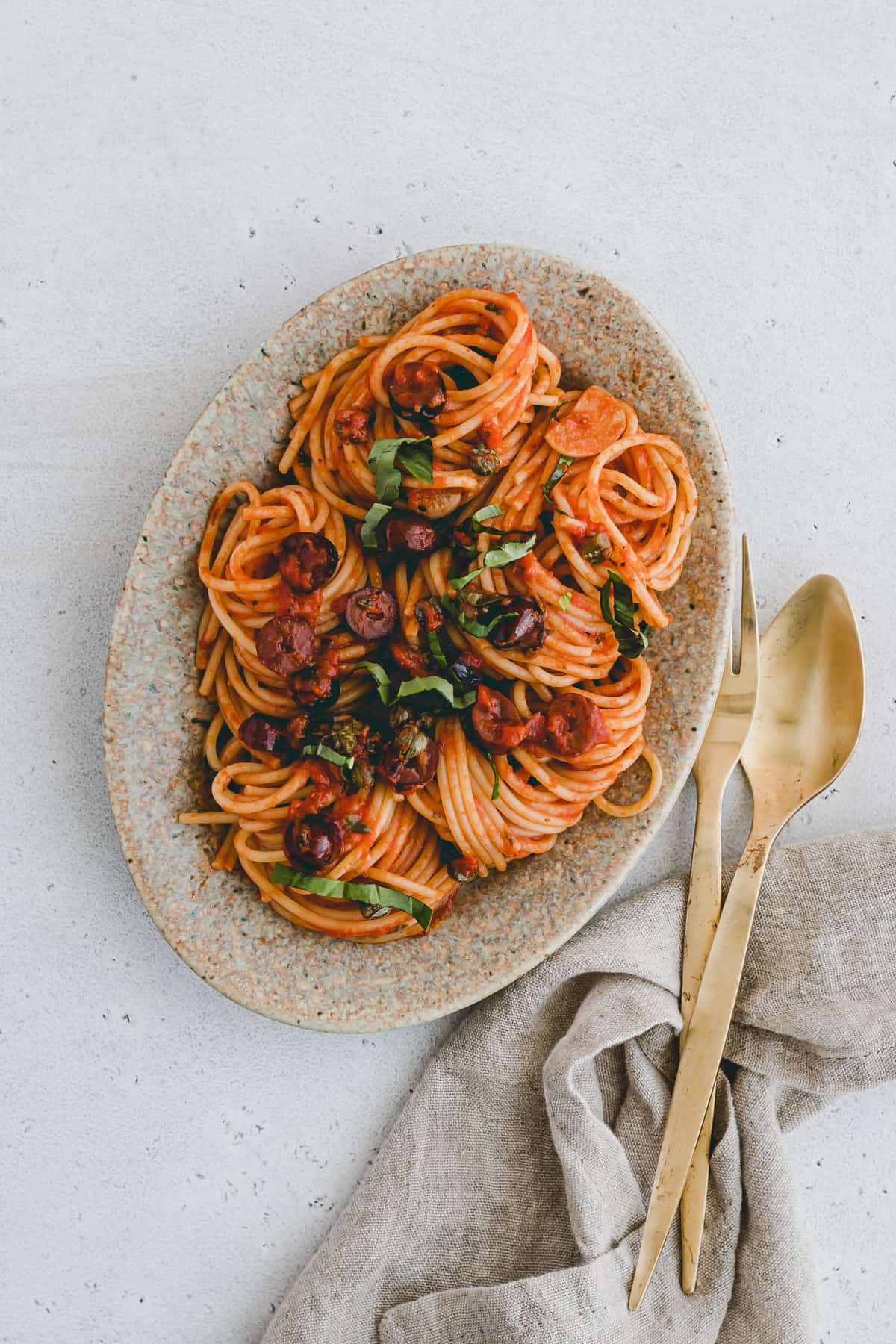 vegan puttanesca sauce served with spaghetti