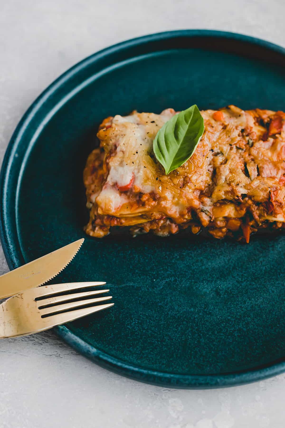 ein stück vegane lasagne auf einem blauen teller