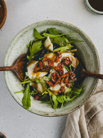 Arugula Parmesan Salad with sun-dried tomatoes in a bowl