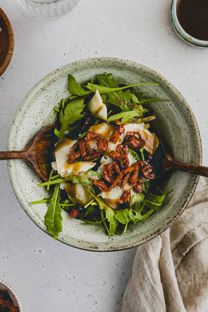 Arugula Parmesan Salad with sun-dried tomatoes in a bowl