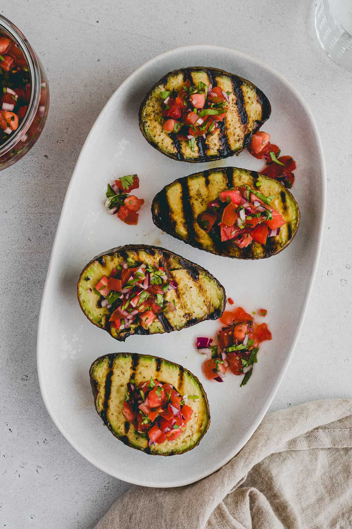 grilled avocado served on a white plate