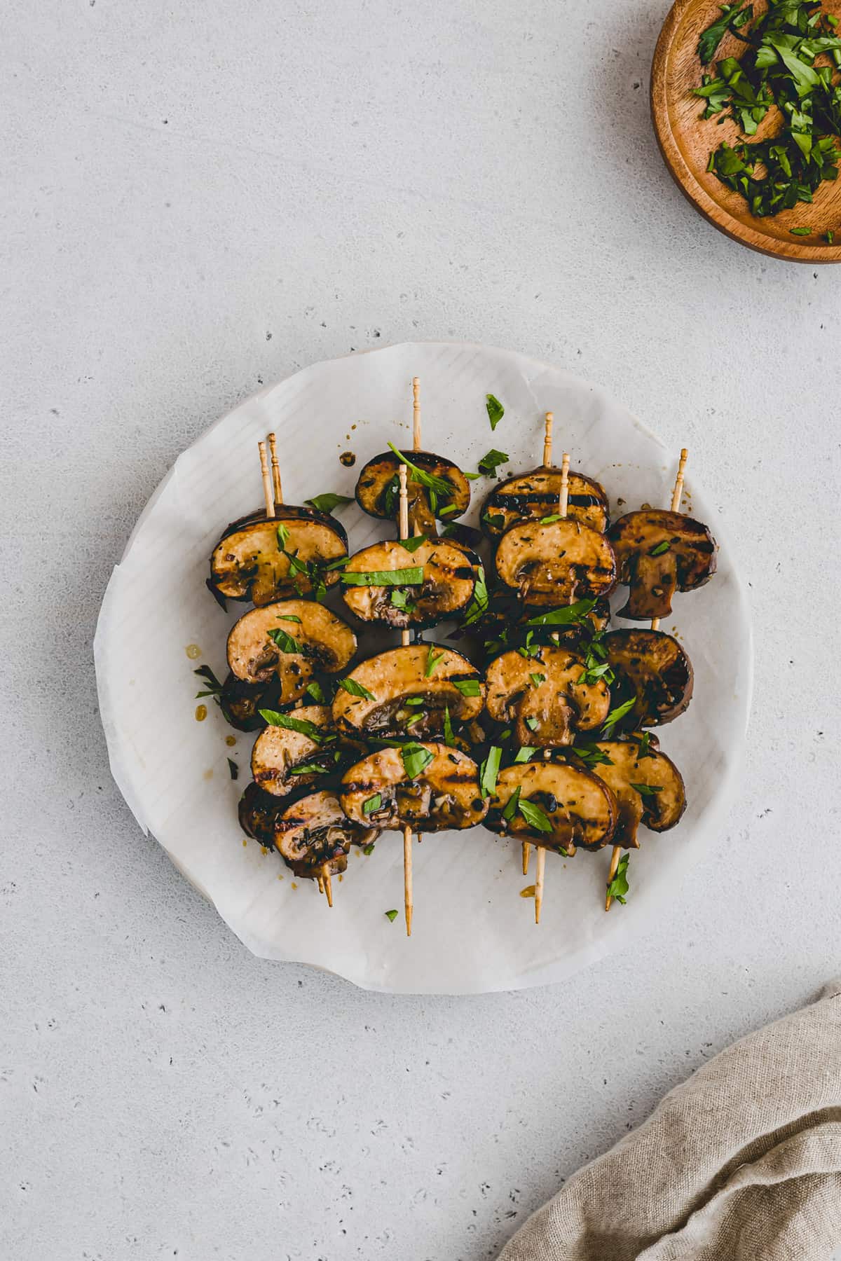 grilled mushrooms garnished with parsley on a plate