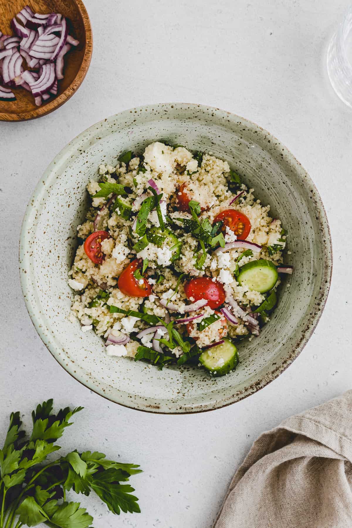 coucous salad with feta and raw vegetables in a bowl