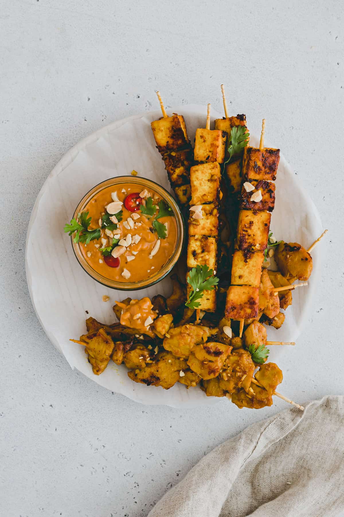 vegan tofu satay skewers with satay sauce on a plate