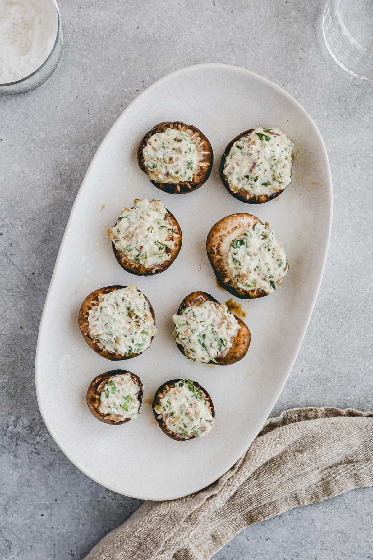 grilled stuffed mushrooms with cream cheese on a serving plate