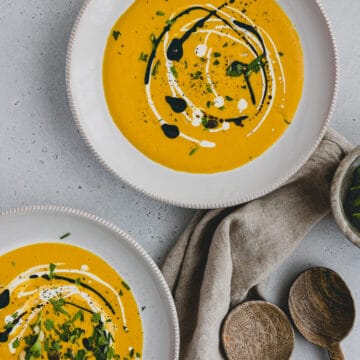 red kuri squash soup in two soup plates
